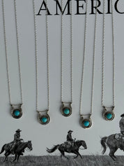Necklaces with turquoise stones on a white card with 'American West' branding.