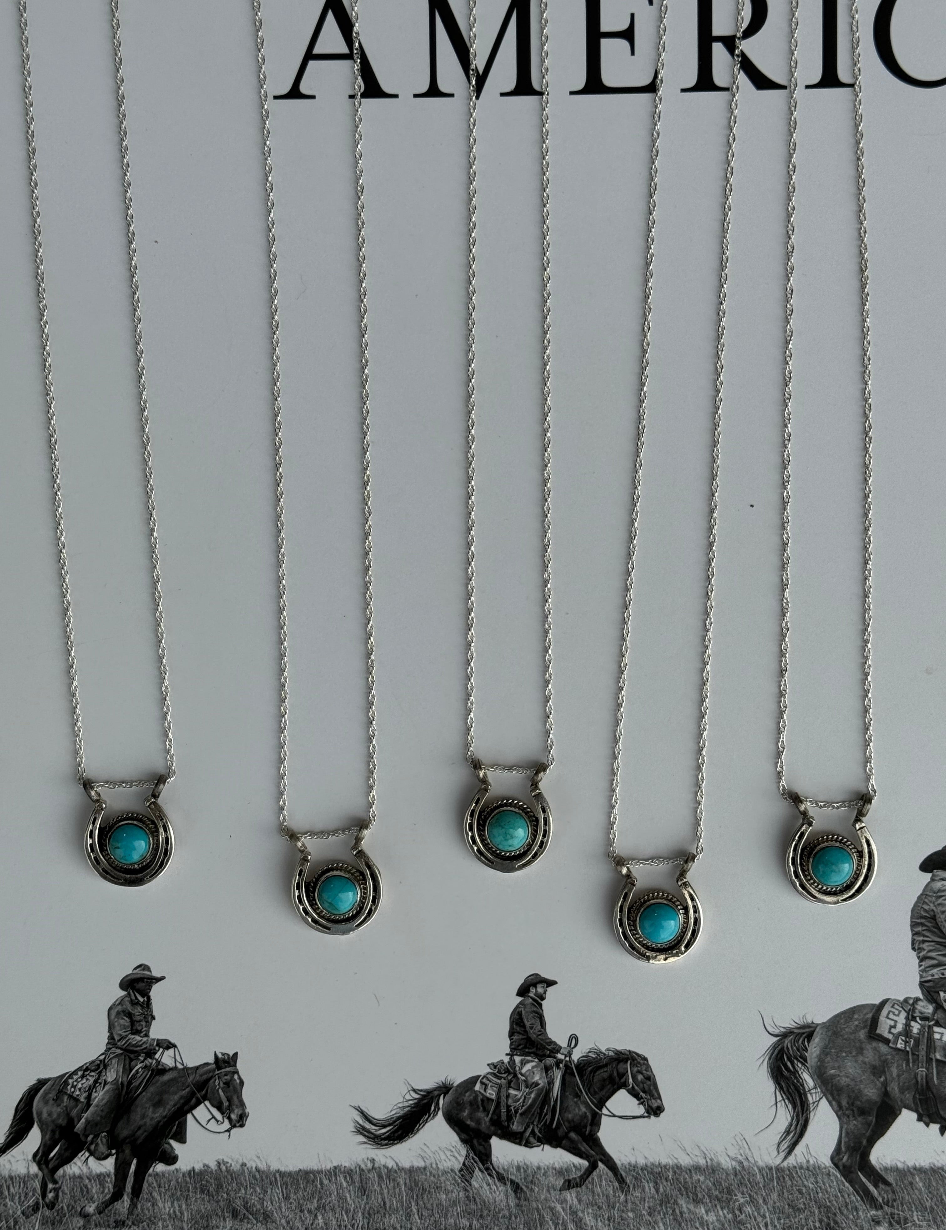 Necklaces with turquoise stones on a white card with 'American West' branding.