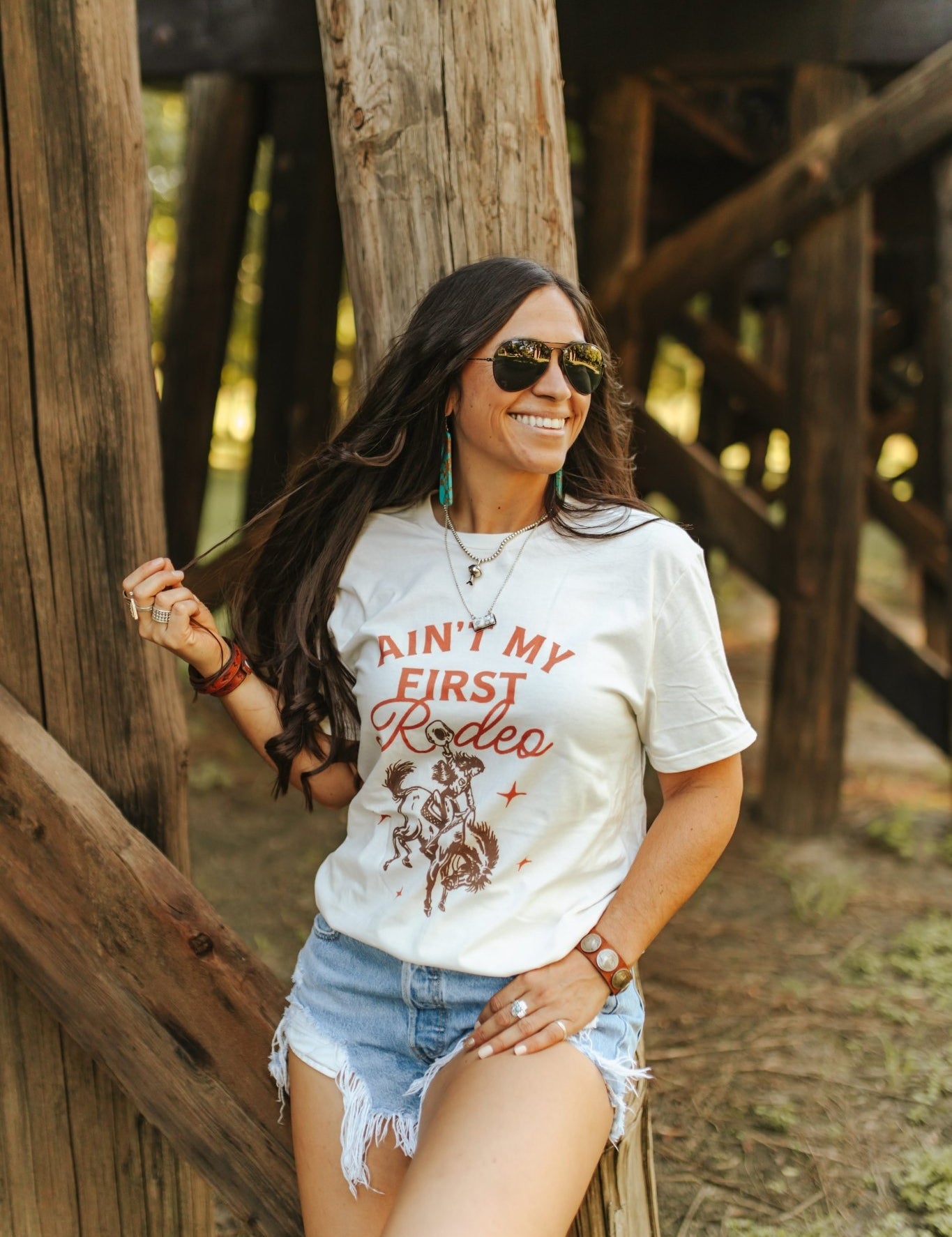Ain't My First Rodeo Cowgirl Graphic TeeNaturalS