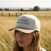 But Daddy He's A Cowboy Beige Embroidered Trucker Hat