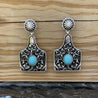 turquoise and silver fleur cattle tag earrings